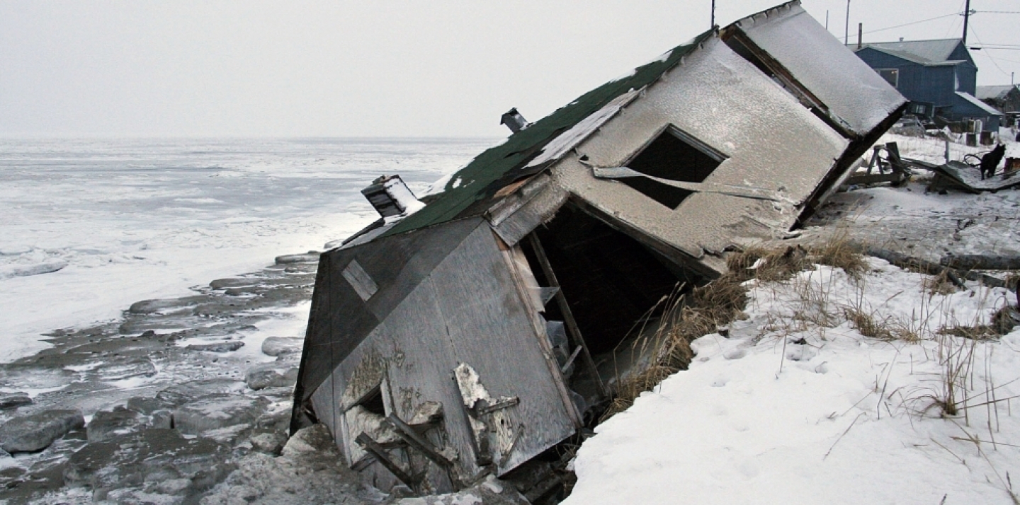 In this Dec. 2006 photo, an abandoned house at the west end of Shishmaref, Alaska, sits on the beach after sliding off during a fall storm in 2005. (AP Photo/Diana Haecker, File)