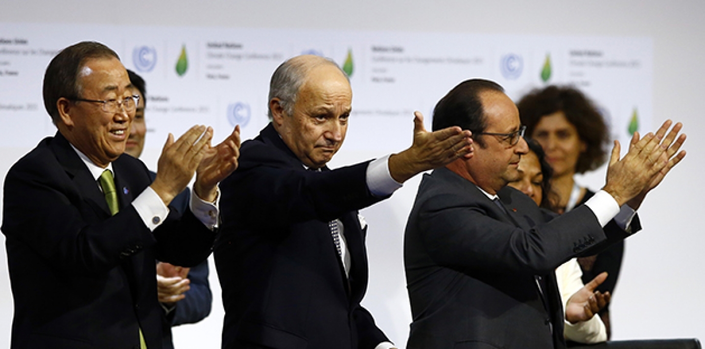 French President Francois Hollande, right, French Foreign Minister and President of the COP21 Laurent Fabius, center, and UN Secretary General Ban ki-Moon applaud after the final conference at the COP21, on Saturday, Dececmeber 12, 2015. (AP Photo/Francois Mori)