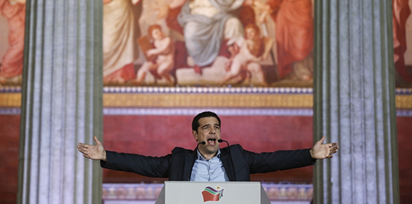 In this photo taken in January 2015, leader of SYRIZA left-wing party Alexis Tsipras speaks to his supporters after his election victory outside Athens University Headquarters. (AP Photo/Petros Giannakouris)