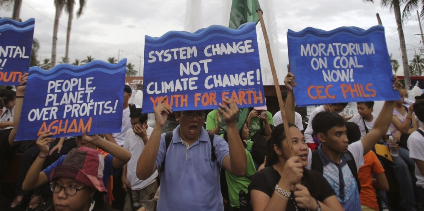 Filipino activists shout slogans during a play depicting the effects of climate change as they join the Climate Solidarity Prayer March in Manila back in November 2015. (AP Photo/Aaron Favila)