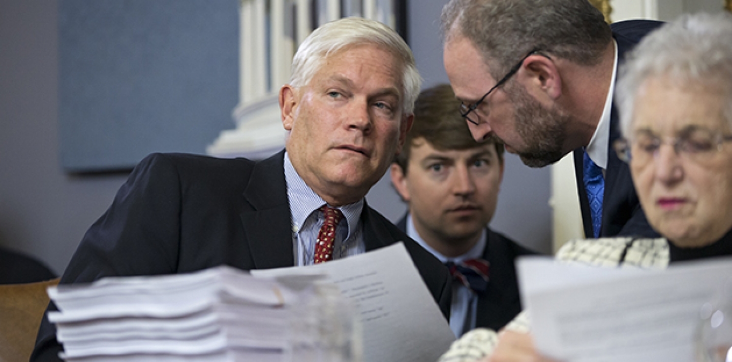 House Rules Committee Chairman Pete Sessions, left, with Rep. Virginia Foxx, right, confers with staff as the panel examines the $1.1 trillion spending bill to fund the government for the 2016 budget year and extend $680 billion in tax cuts for businesses and individuals, at the Capitol in Washington, Dec. 16, 2015. (AP Photo/J. Scott Applewh)