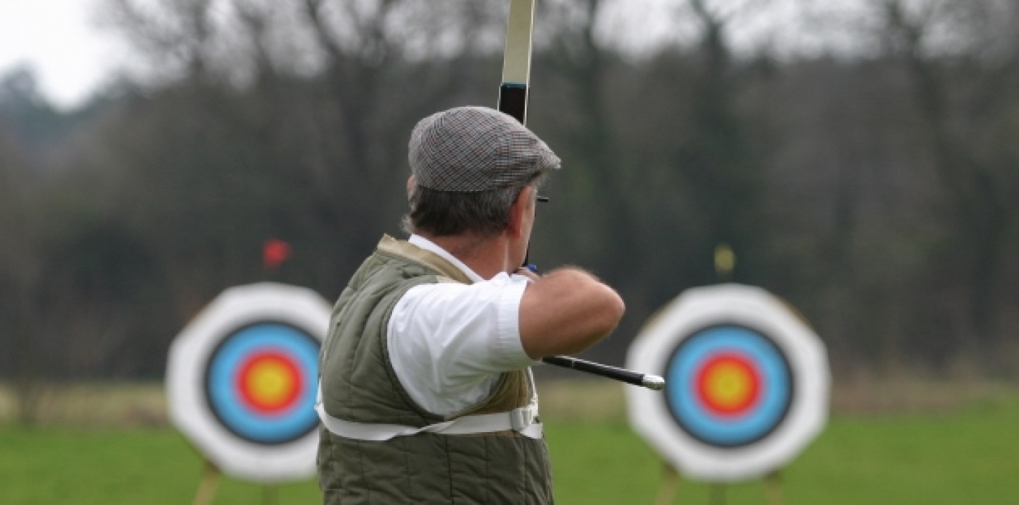 A sports archer aims at targets. (Shutterstock)
