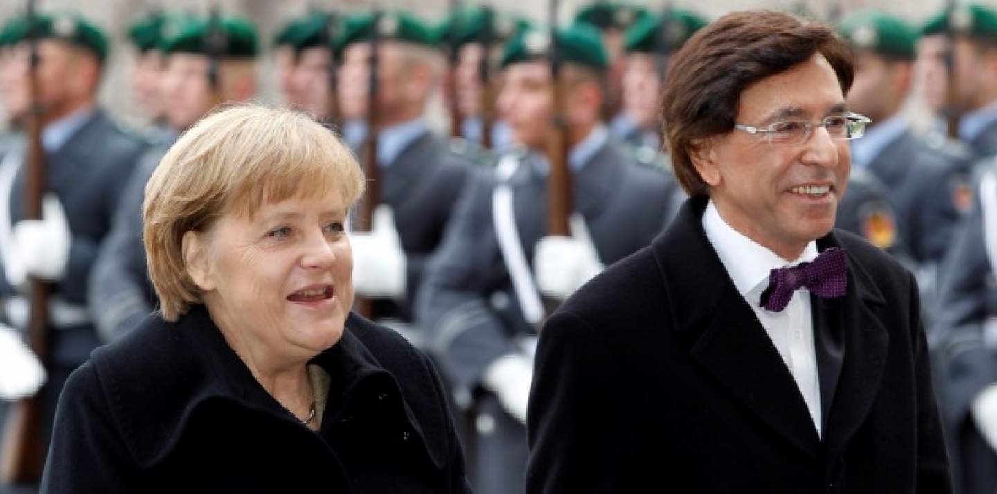 German Chancellor Angela Merkel, left, welcomes the Prime Minister of Belgium, Elio Di Rupo, right, with military honors at the chancellery in Berlin (AP Photo/Michael Sohn).