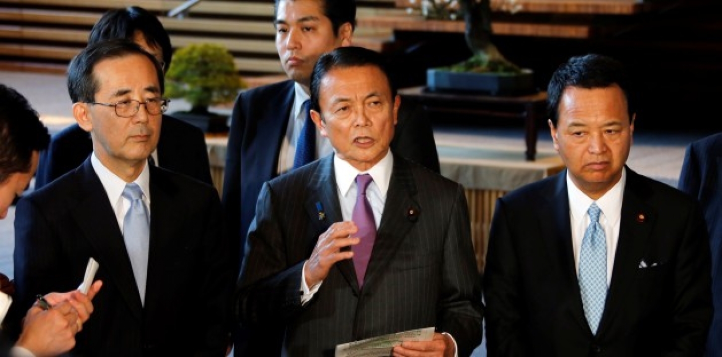 Japan's Finance Minister Taro Aso, center, along with Economics Minister Akira Amari, right, and Bank of Japan Gov. Masaaki Shirakawa, left, speaks to reporters after meeting with Japan's Prime Minister Abe who declared a "monetary regime change" in January. (AP Photo/Koji Sasahara)