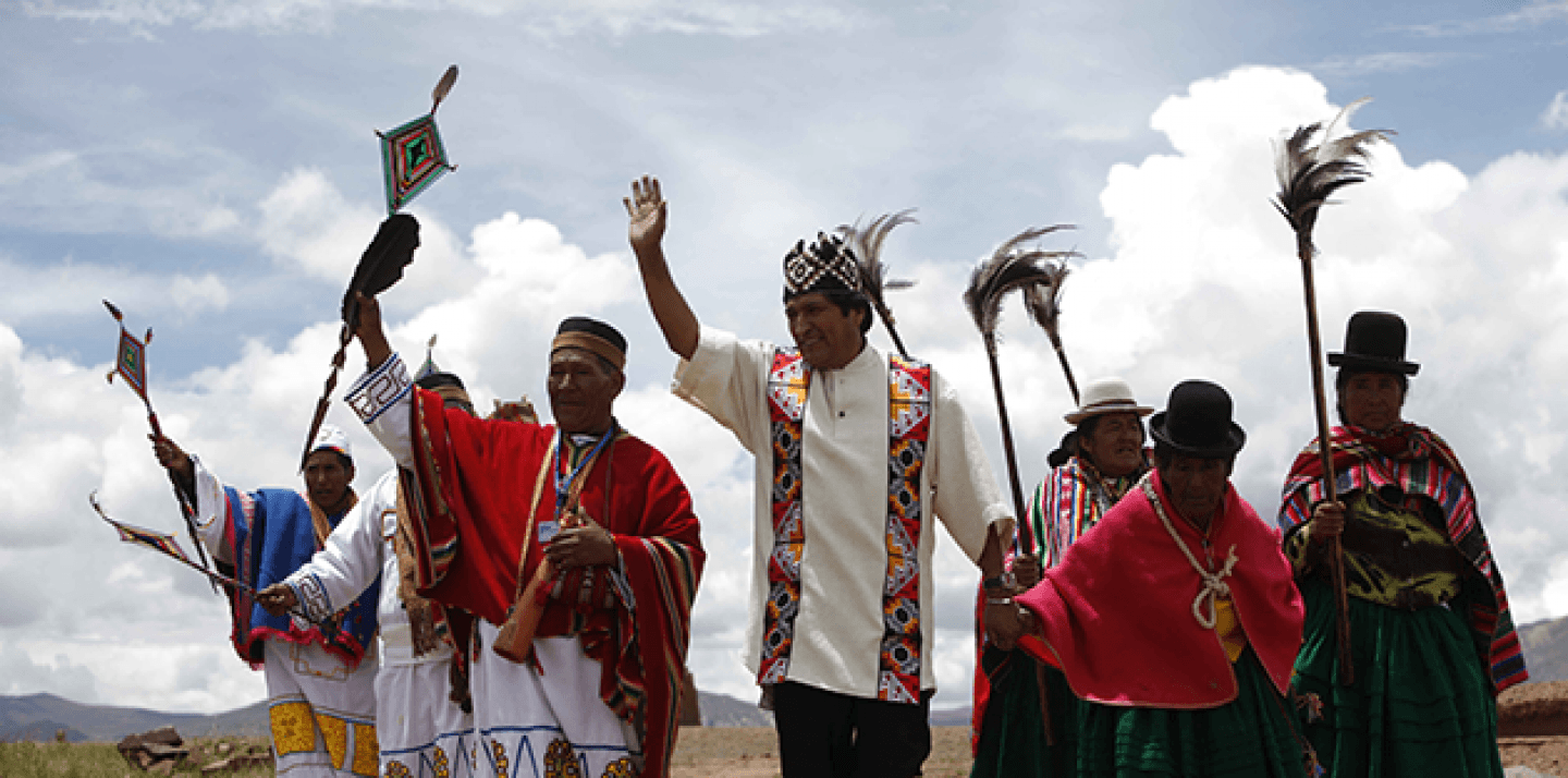 Bolivia's President Evo Morales, center, waves as he is escorted by shamans during an indigenous religious ceremony that recognizes Morales as the country's leader in Tiwanaku, Bolivia. (AP Photo/Dado Galdieri)