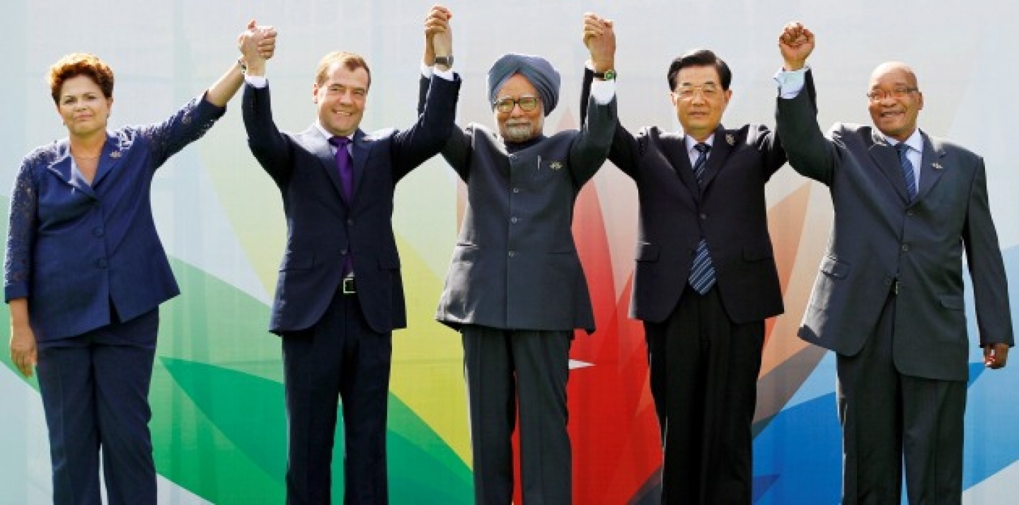 Leaders raise their arms together during the group picture for the BRICS 2012 Summit in New Delhi, India (AP Photo/Saurabh Das).