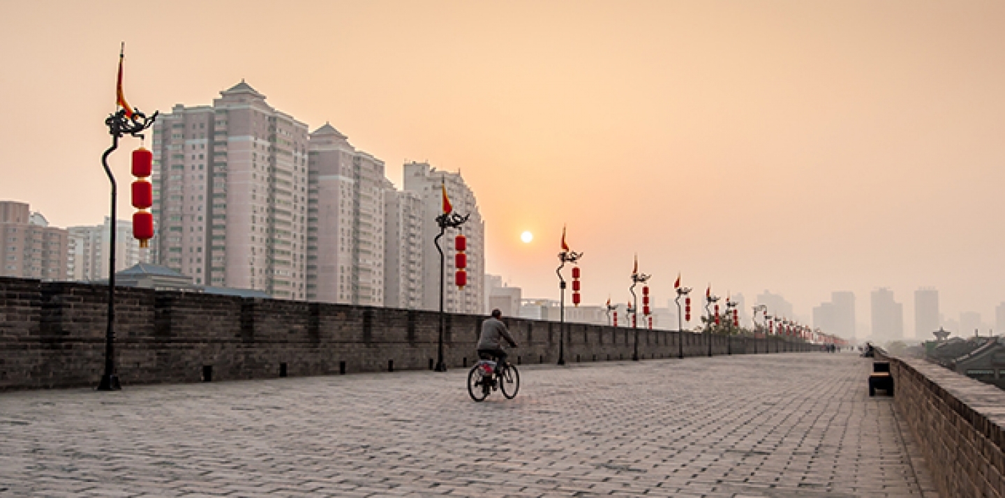A bicycle rides at sunset in Xian, China. (Shutterstock)
