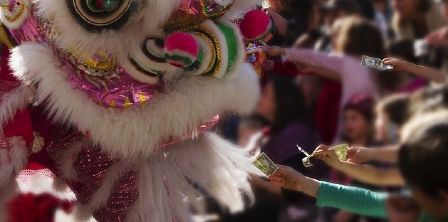 Children offer money to a dragon during celebrations of the Chinese New Year. (Pixbay Image/Lisa Redfern)