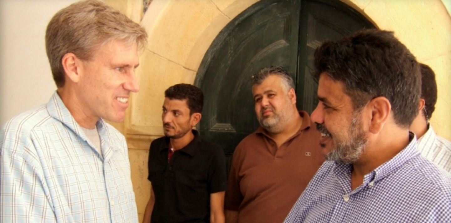 U.S. Ambassador to Libya Christopher Stevens, left, greets a Libyan man in Tripoli, two weeks prior to Stevens being killed in an attack on the U.S. consulate in Benghazi by protesters angry over an anti-Muslim film. (AP Photo)