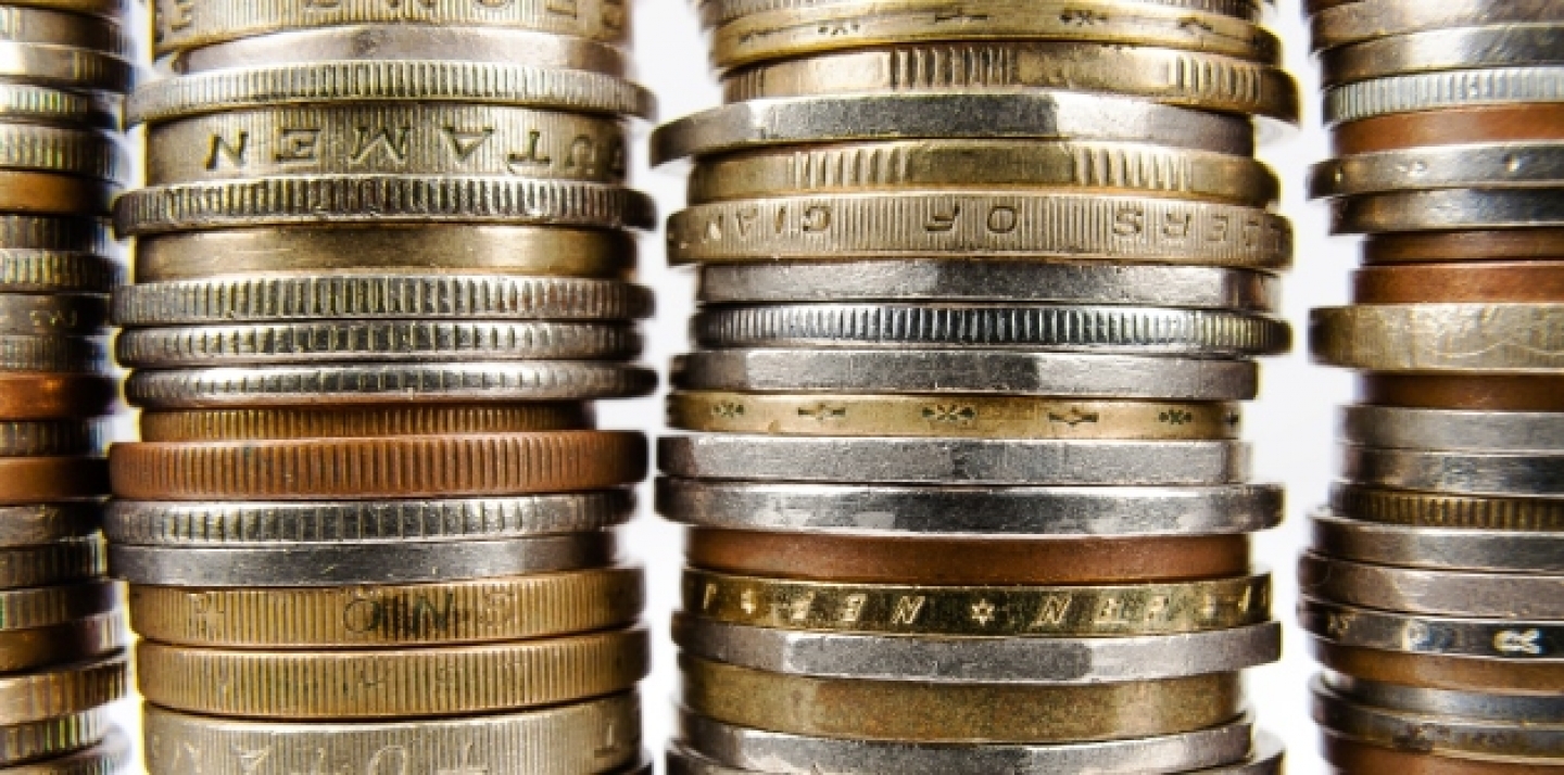 Various coins arranged in stacks shown up close (Shutterstock).