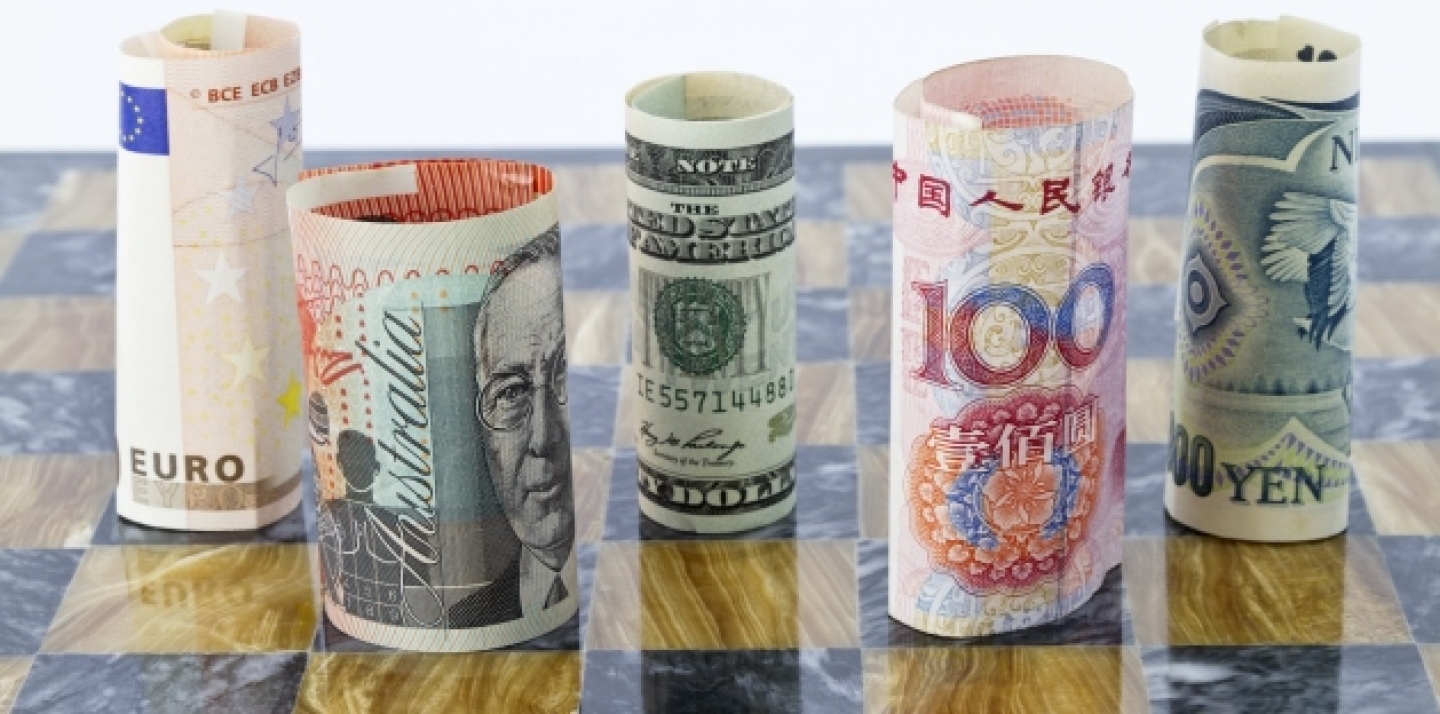Five currencies that influence global financial investments staged on a chess board. (Shutterstock)