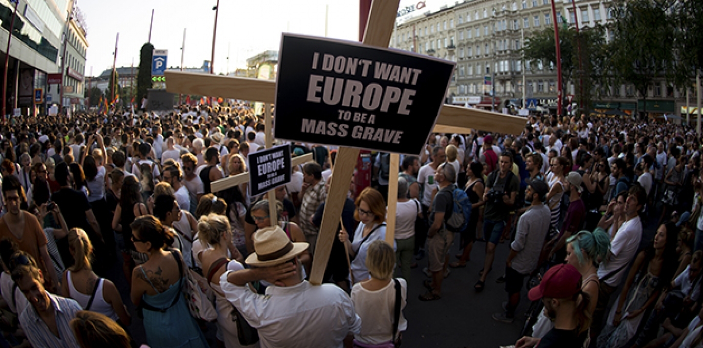 People demonstrate for a change in the European refugee policy in the Austrian capital Vienna Monday, Aug. 31, 2015. (AP Photo/Christian Bruna)
