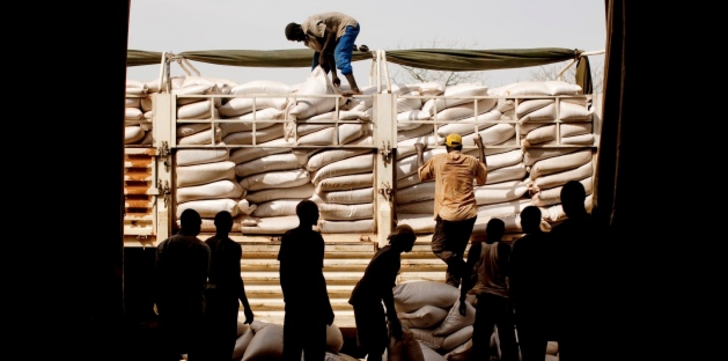Workers unload food for distribution at the Yida refugee camp in South Sudan, May 2012 (AP Photo/Pete Muller).