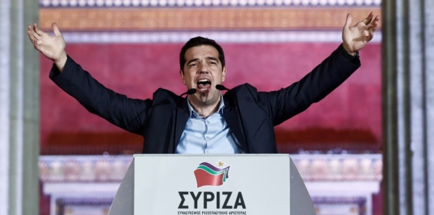 Leader of Syriza left-wing party Alexis Tsipras speaks to his supporters outside Athens University Headquarters, Sunday, Jan. 25, 2015. (AP Photo/Petros Giannakouris)