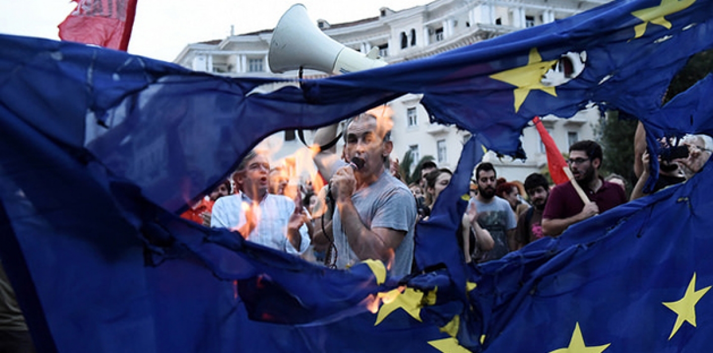 Members of left wing parties burn a European Union flag during a protest in the northern Greek port city of Thessaloniki. (AP Photo/Giannis Papanikos)