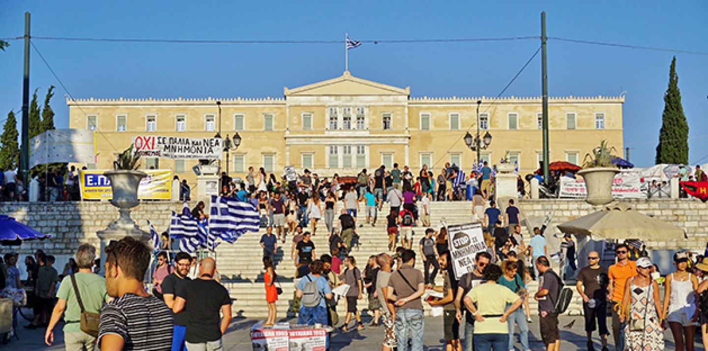 Anti-austerity protesters and Greek flags in front of the Parliament on Syntagma Square in Athens. (Shutterstock)