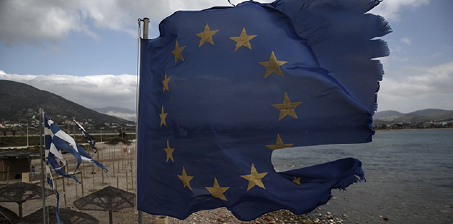 Ruined EU and Greek flags fly in tatters from a flag pole at a beach at Anavissos village, southwest of Athens, on Monday, March 16, 2015. (AP Photo/Yorgos Karahalis)