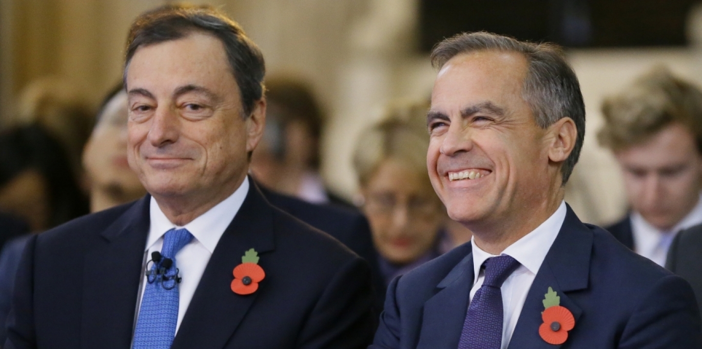 Mark Carney, Governor of The Bank of England, right, sits with Mario Draghi President of the European Bank, during The Bank of England's Open Forum Conference in London, Wednesday, Nov. 11, 2015. (AP Photo/Kirsty Wigglesworth)