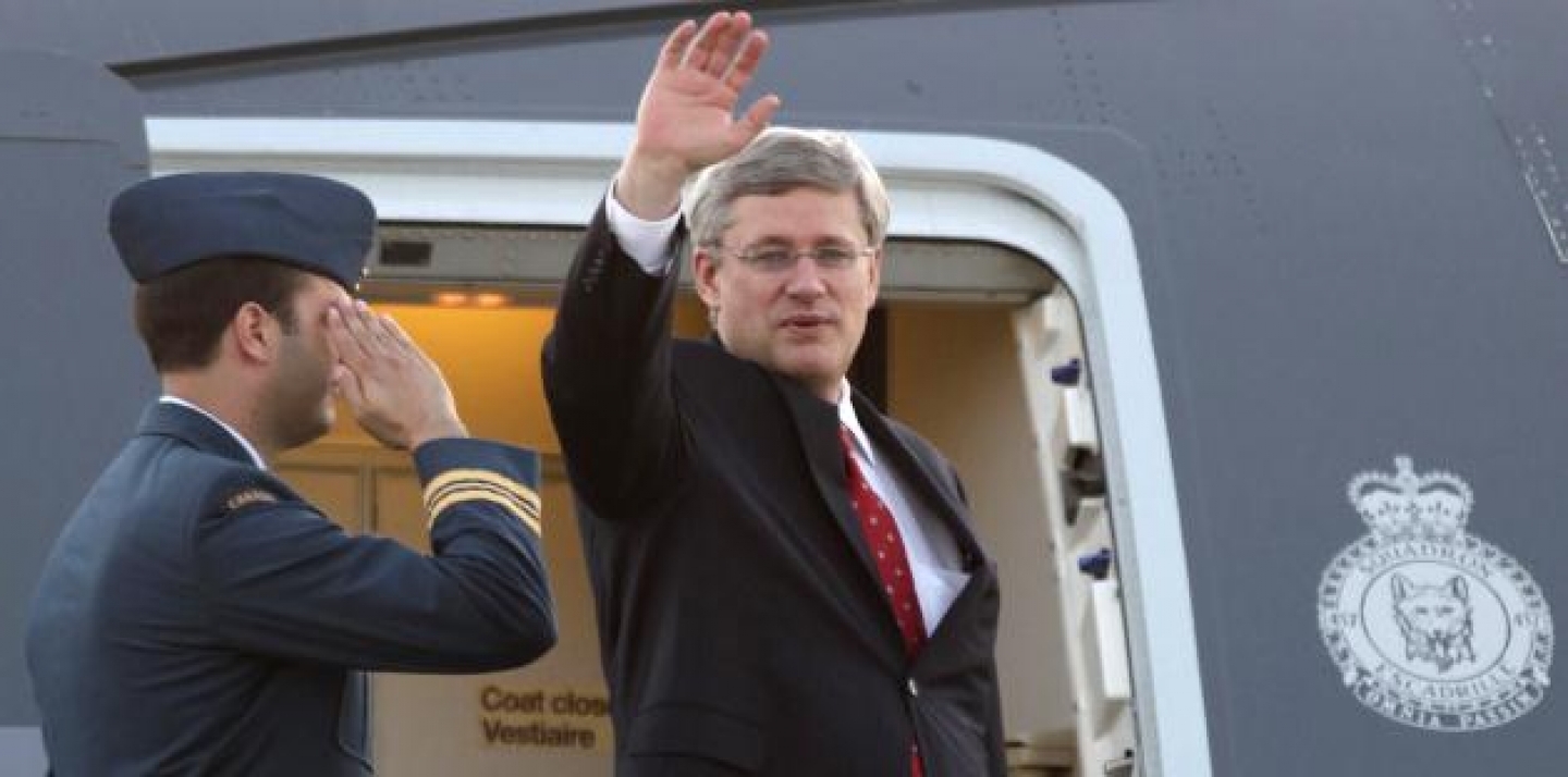 Canada's Prime Minister Stephen Harper waves to photographers upon his arrival to Los Cabos international airport to attend the G-20 Summit (AP Photo/Eduardo Verdugo)