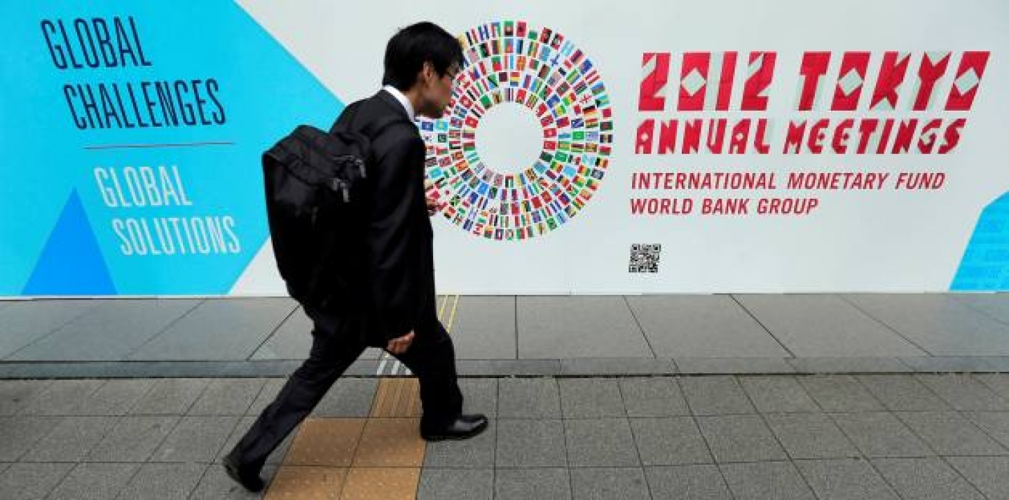 A man walks in front of the venue of the International Monetary Fund and World Bank meeting (AP Photo/Itsuo Inouye).