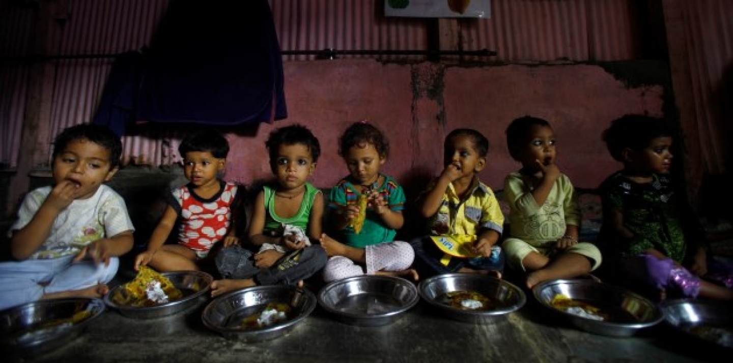 Malnourished Indian children eat a meal at the Apanalaya center, an organization working for the betterment of slum children, in Mumbai,India. (AP Photo/Rafiq Maqbool)