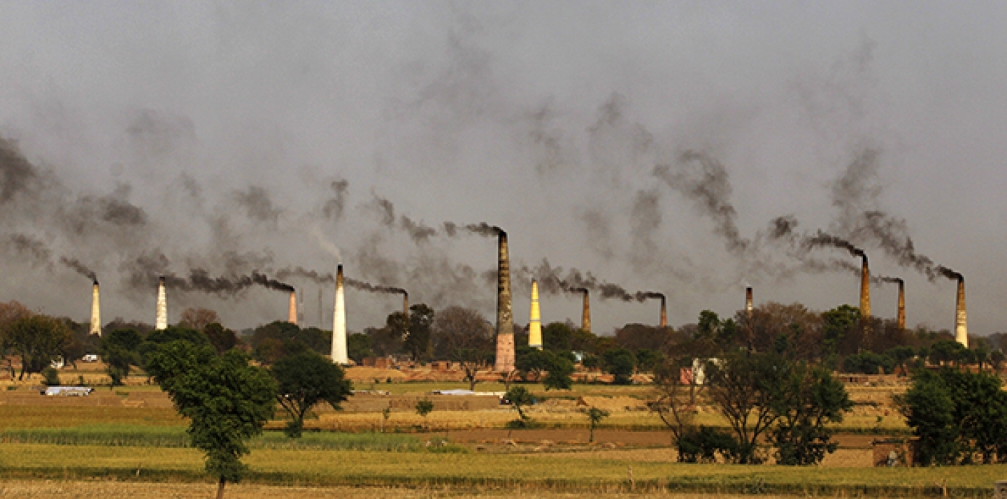 Smoke emits from the chimneys of numerous brick kilns on the outskirts of New Delhi, India. (AP Photo/Altaf Qadri)