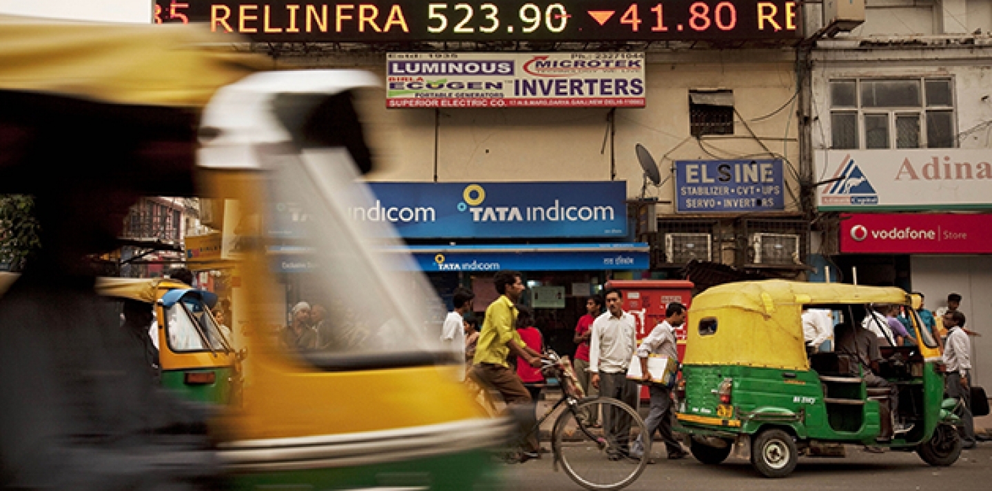 A stock ticker shows closing figures on the Bombay Stock Exchange (BSE) on a street in New Delhi, India. (AP Photo/Kevin Frayer)