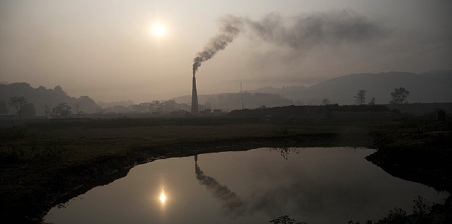 Smoke rises from a brick kiln on the outskirts of Gauhati, India, Monday, Jan. 26, 2015. (AP Photo/ Anupam Nath)