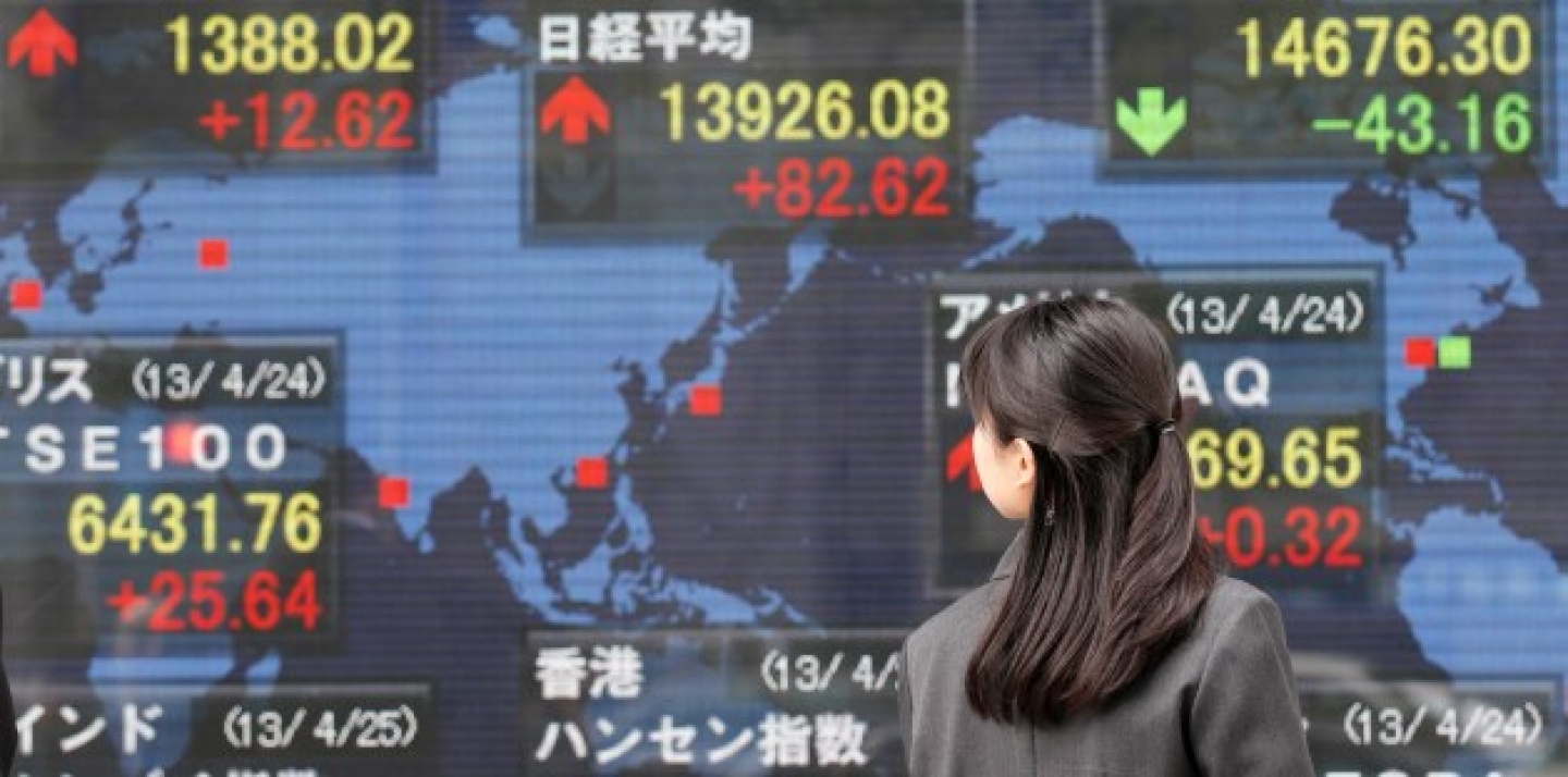 A woman look at an electronic stock board of a securities firm in Tokyo, Thursday, April 25, 2013. (AP Photo/Koji Sasahara)