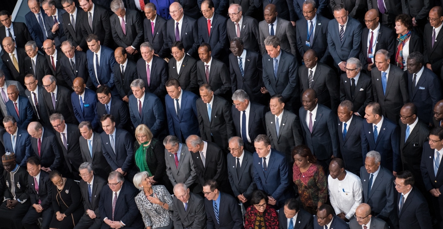 Christine Lagarde looks over her shoulder in the family photo before the IMFC meeting. (IMF Photo/Ryan Rayburn)