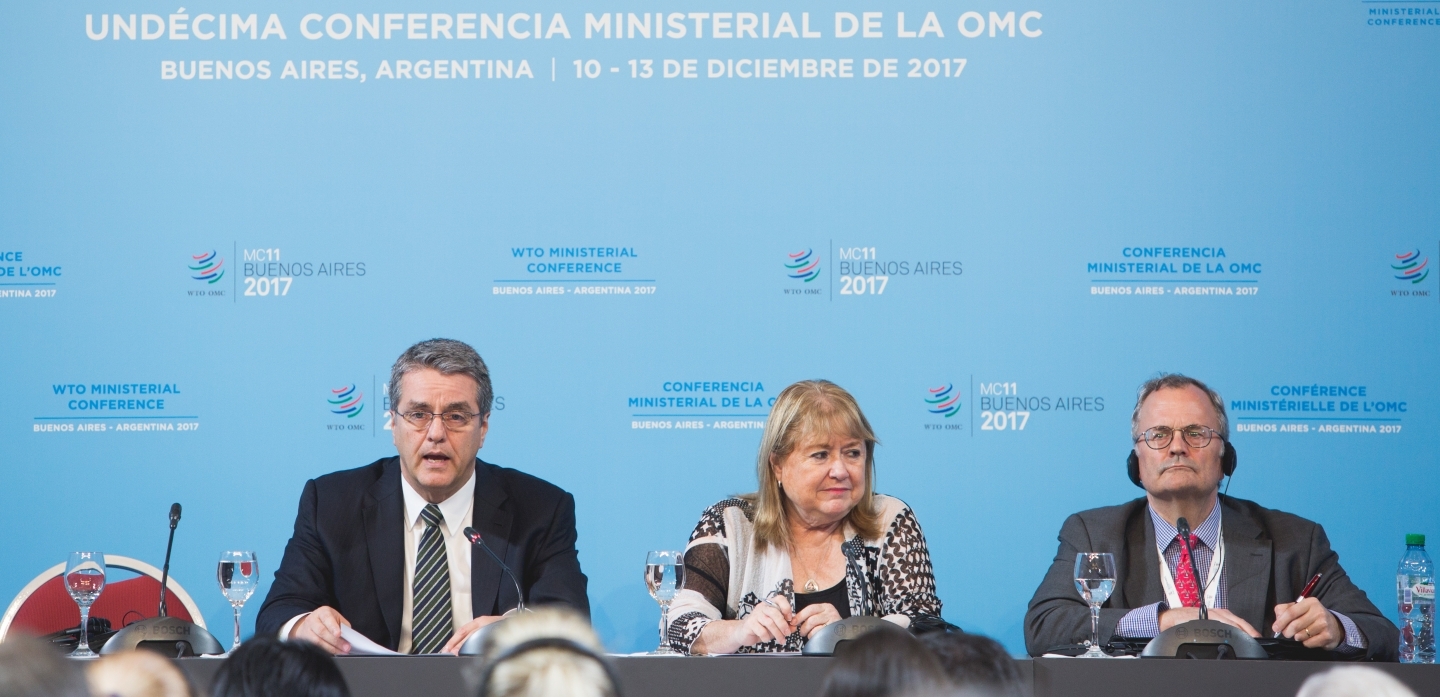 WTO Director-General Roberto Azevêdo, Ministerial Conference Chair Susana Malcorra and WTO Spokesperson Keith Rockwell at the MC11 press conference. (WTO/Cuika Foto)