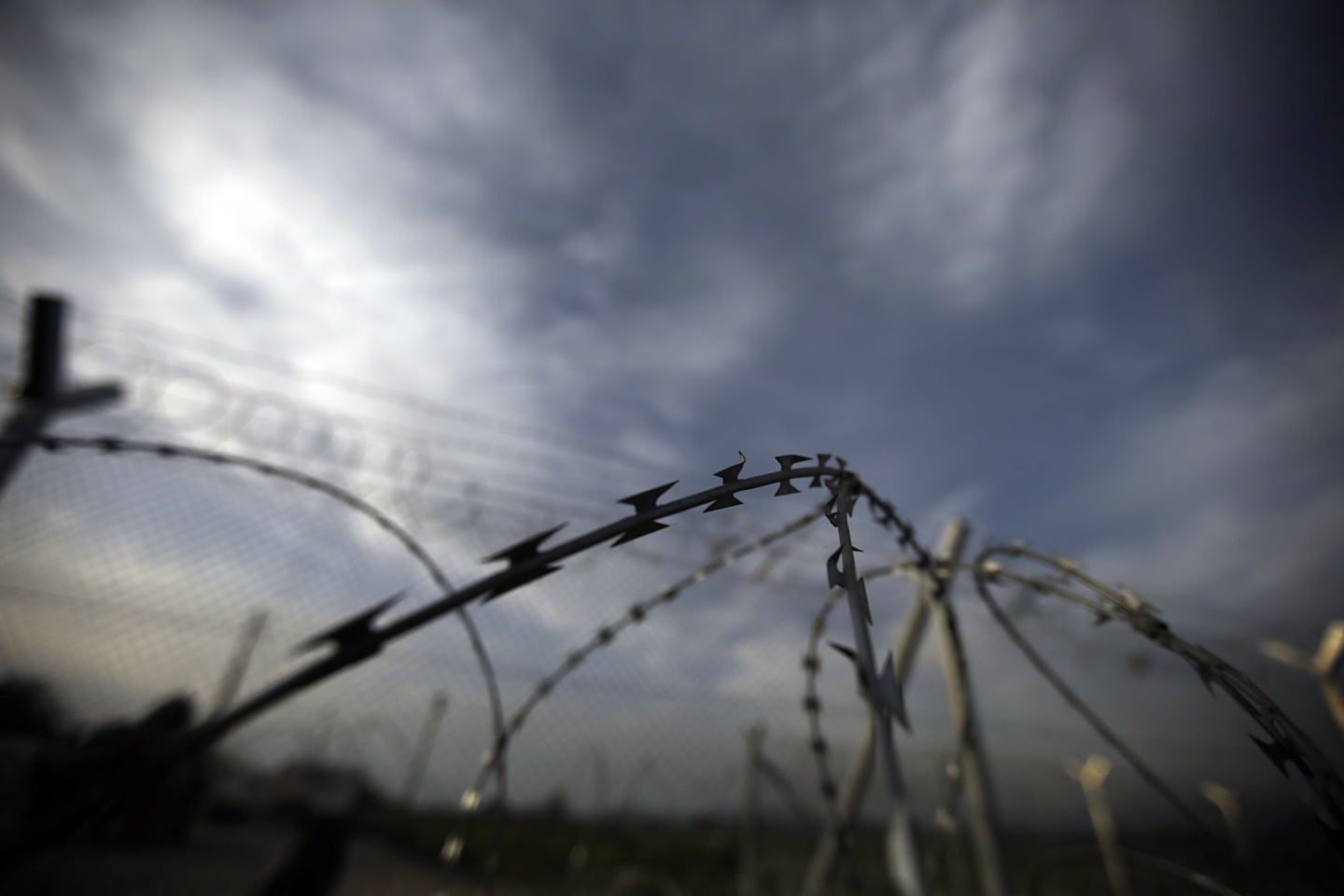 The barbed wire of a border fence by a makeshift camp near a border crossing at Idomeni, Greece (AP Photo/Gregorio Borgia)