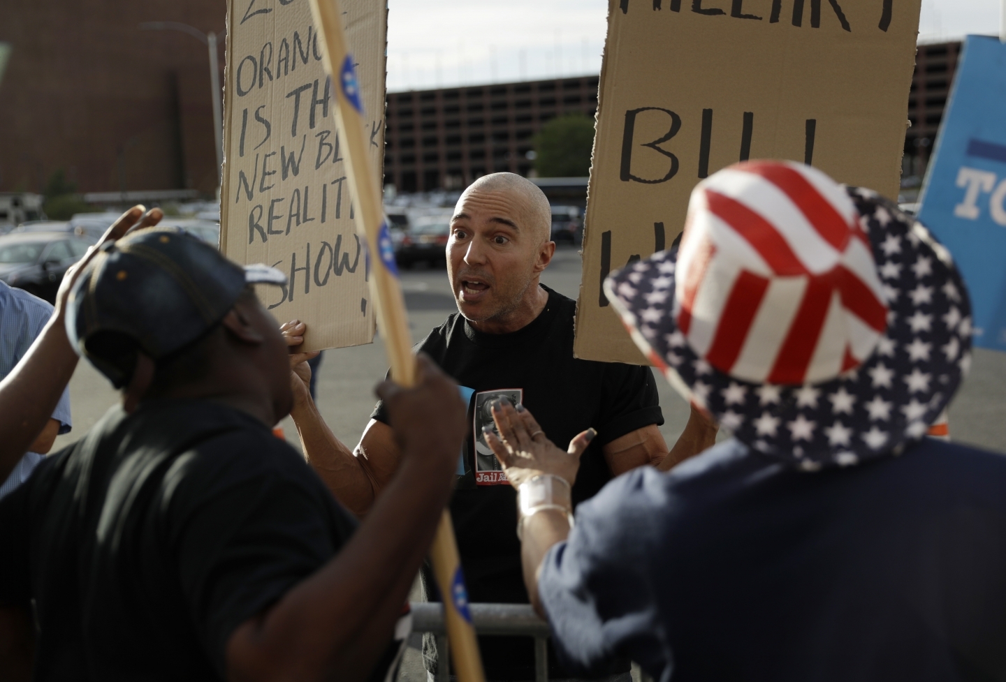 A supporter of Republican presidential candidate Donald Trump argues with supporters of Democratic presidential candidate Hillary Clinton (AP Photo/John Locher)