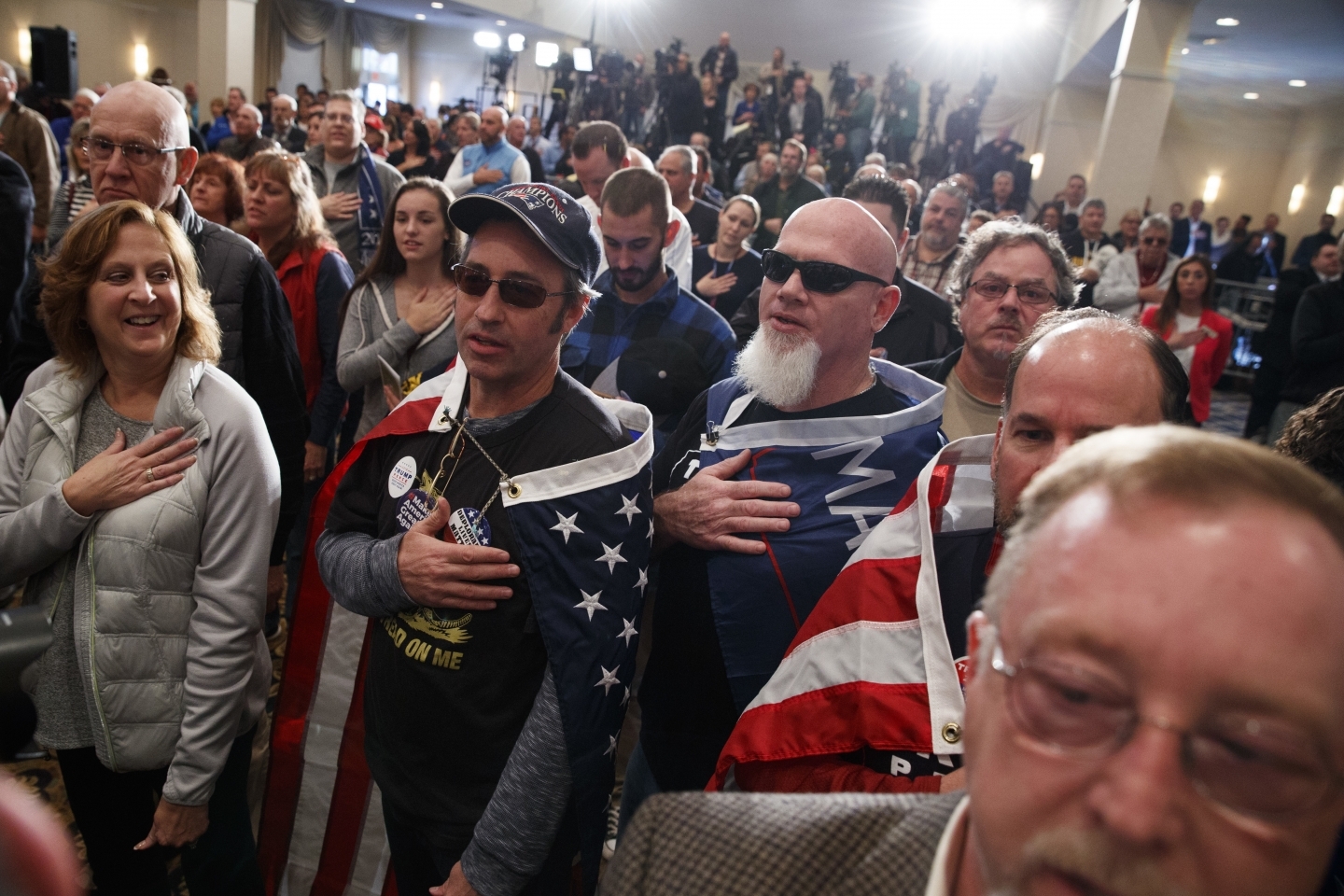 Supporters say the pledge of allegiance during a campaign rally (AP Photo/ Evan Vucci)