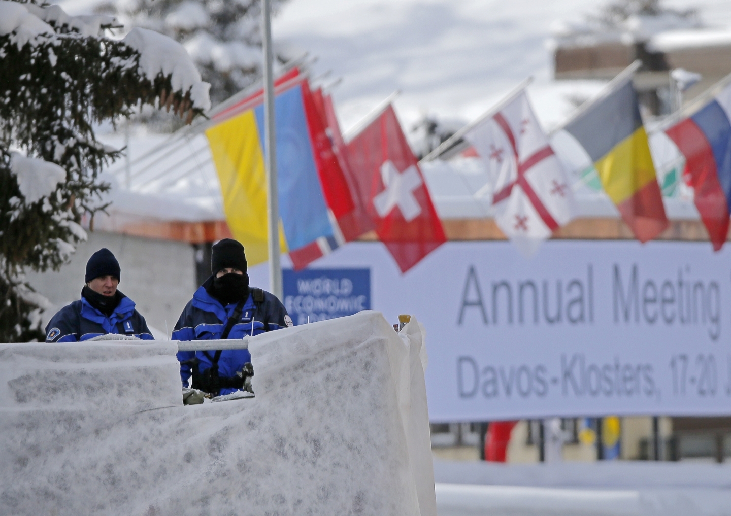 Swiss police officers guard the entrance to the World Economic Forum in Davos, Switzerland (AP Photo/Michel Euler)