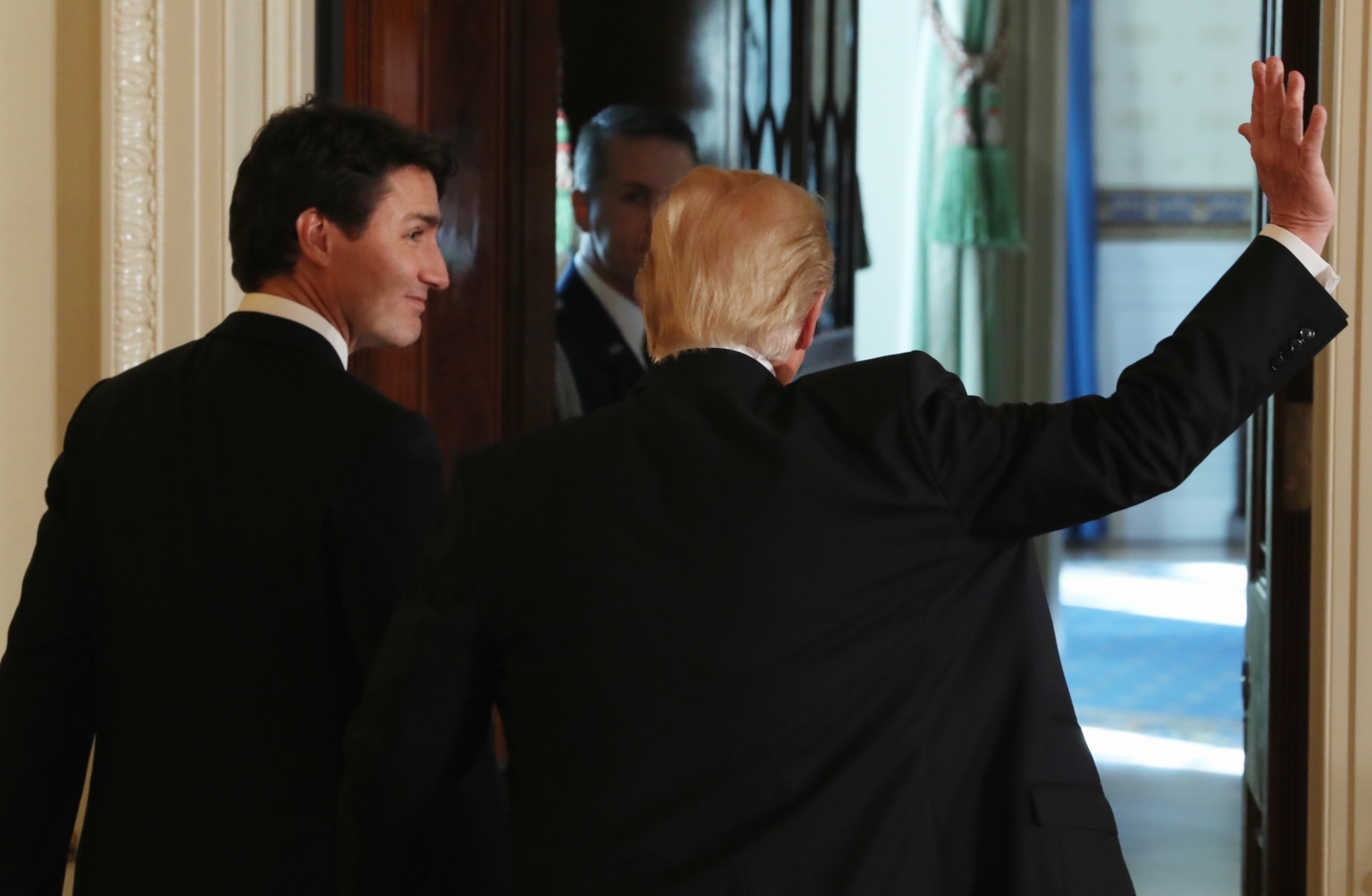 Trump waves as he and Trudeau leave the East Room of the White House, Monday, Feb. 13, 2017. (AP Photo/Andrew Harnik)