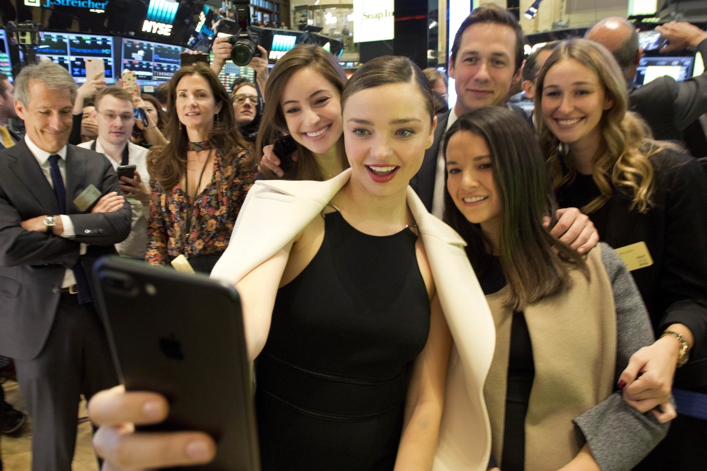 Model Miranda Kerr takes selfie during NYSE opening bell to mark Snap IPO. Kerr is engaged to Snap CEO Evan Spiegel. (AP Photo/Mark Lennihan)
