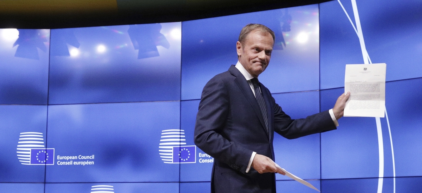 European Council President Donald Tusk holds a letter signed by UK Prime Minister Theresa May starting the clock on Brexit (AP Photo/Olivier Matthys)