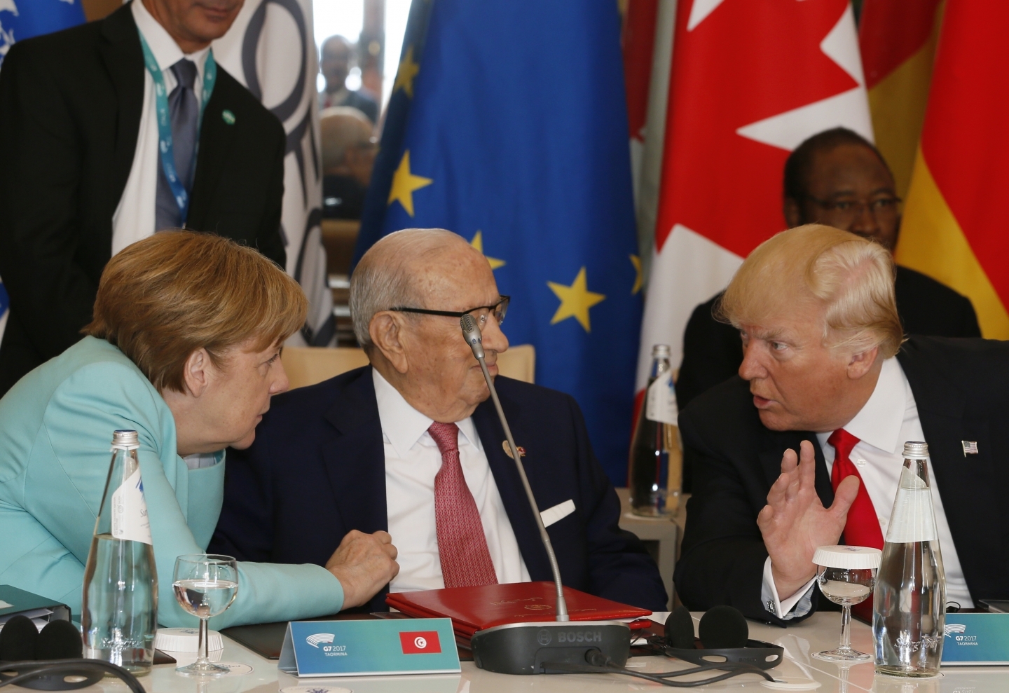 German Chancellor Angela Merkel and US President Donald Trump speak with Tunisian President Beji Caid Essebsi at roundtable during summit in Italy (AP Photo/Domenico Stinellis)