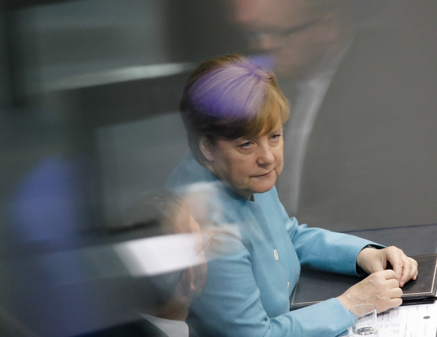 German Chancellor Angela Merkel listens during a debate in the Bundestag about the upcoming G20 Summit (AP Photo/Markus Schreiber)