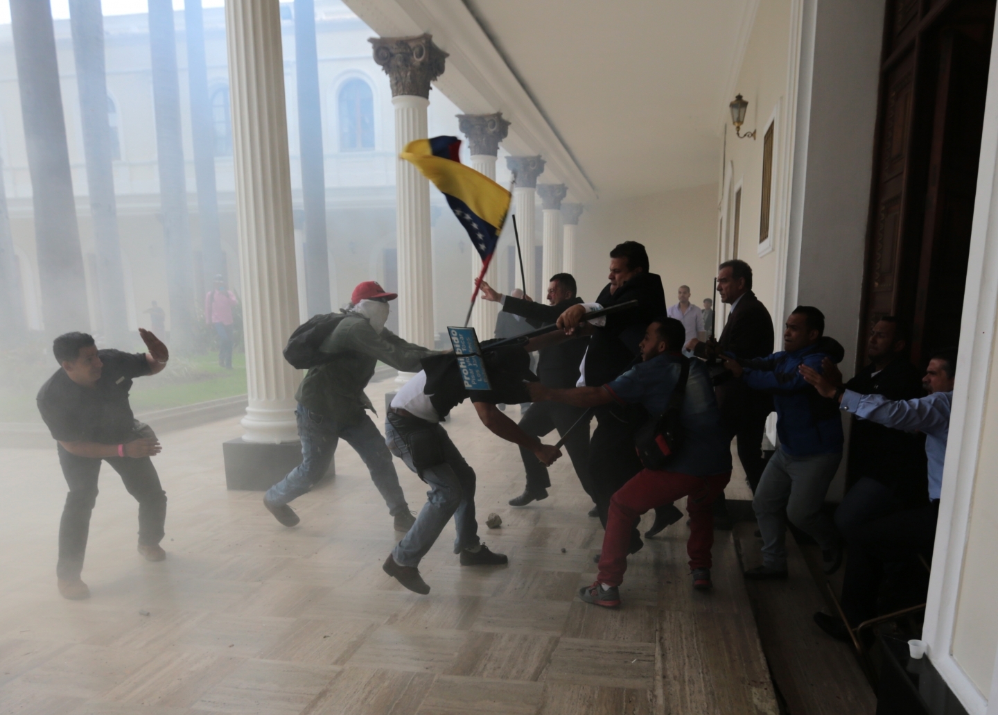 Opposition lawmakers brawl with pro-government militias trying to force their way into the National Assembly in Caracas (AP Photos/Fernando Llano)