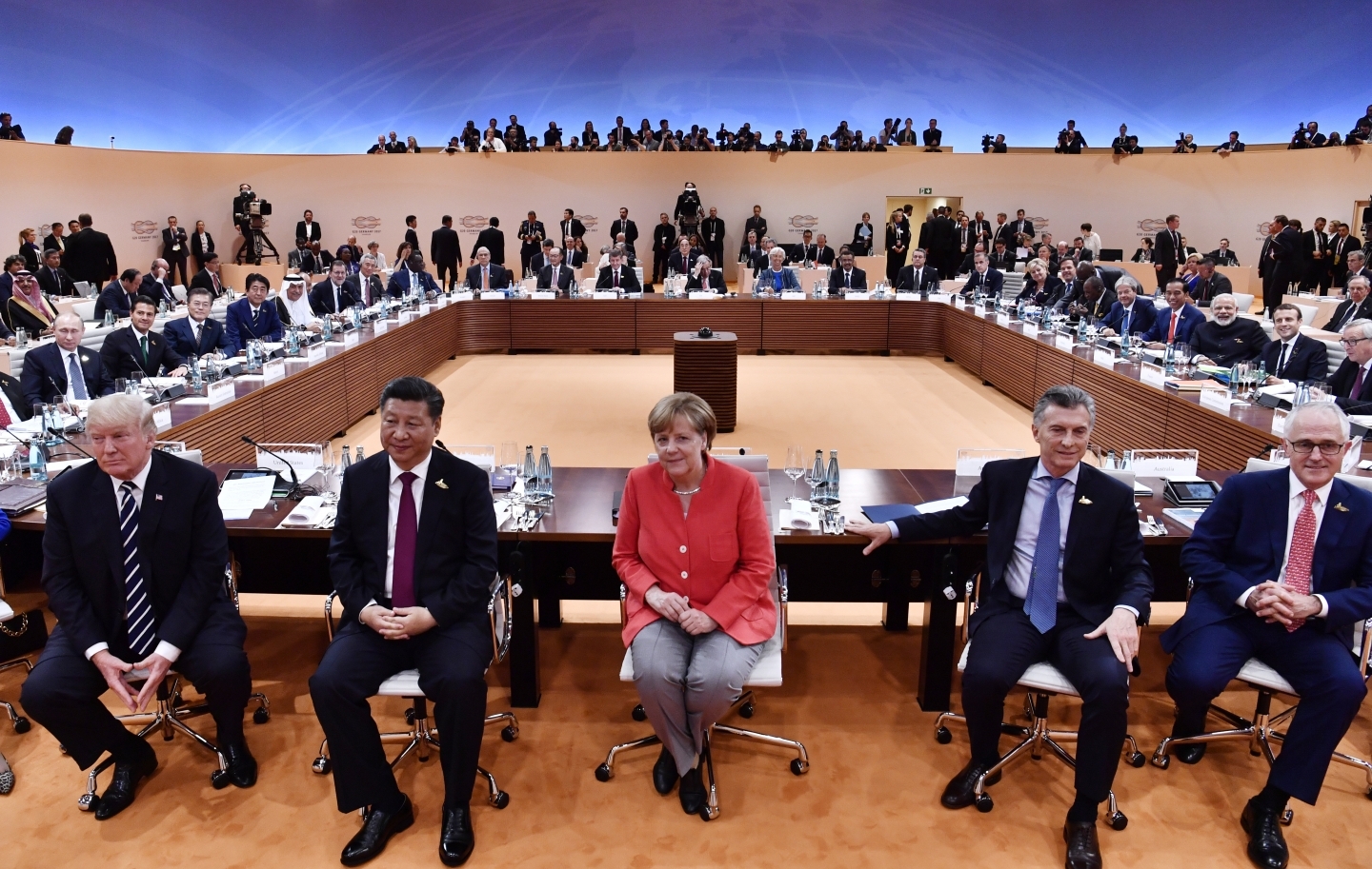US President Donald Trump, China's President Xi Jinping, German Chancellor Angela Merkel, Argentina's President Mauricio Macri and Australia's Prime Minister Malcolm Turnbull turn around for photographers at the start of the first working session of the 2017 G20 meeting in Hamburg. (John MacDougall/Pool Photo via AP)