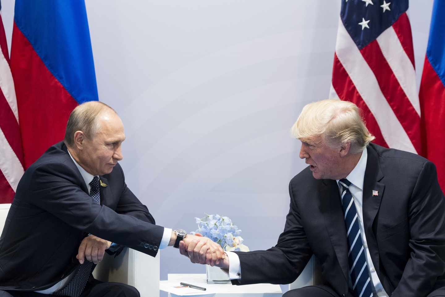 US President Donald Trump shakes hands with Russian President Vladimir Putin during the G20 summit in Hamburg Germany, Friday July 7, 2017. (AP Photo/Marcellus Stein)