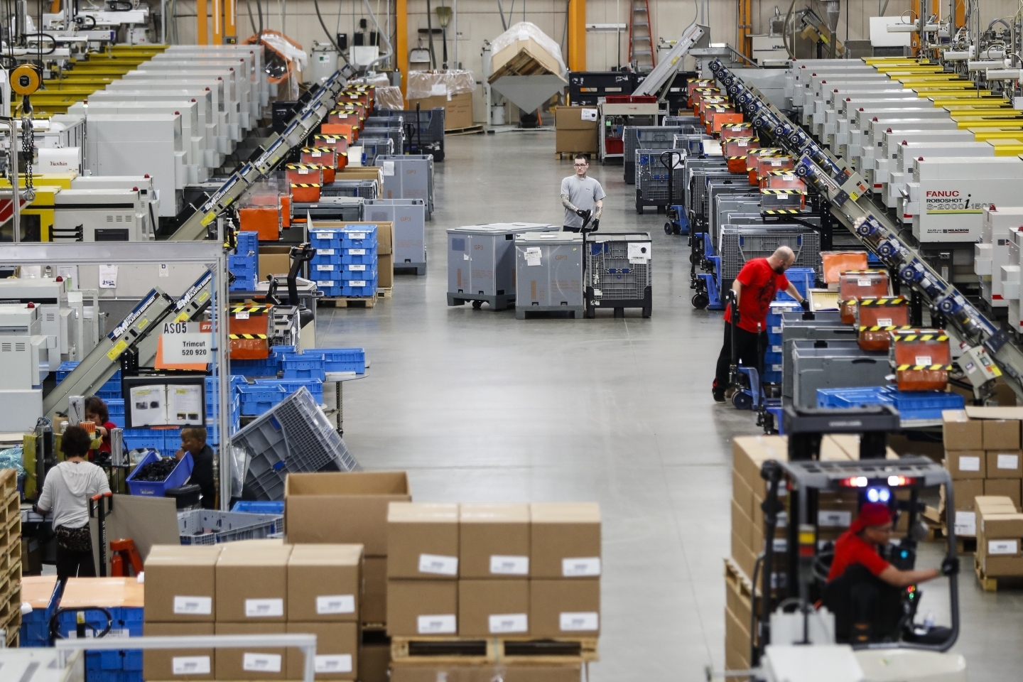 Employees work alongside automated systems on the factory floor at a Stihl Inc. in Virginia Beach. (AP Photo/Chuck Burton)