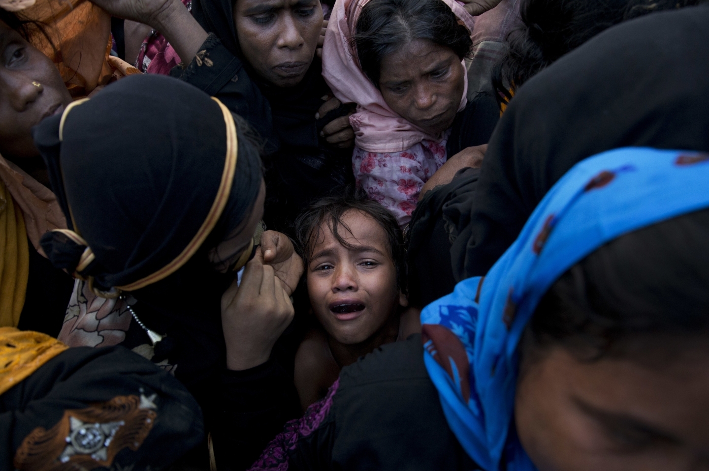 A Rohingya Muslim girl cries as she stands amid a crowd of elders in Cox's Bazar, Bangladesh (AP Photo/Bernat Armangue)