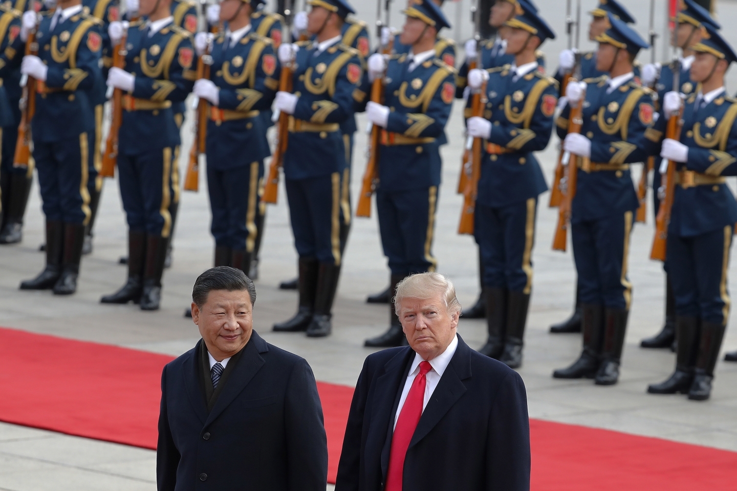 US President Donald Trump walks with Chinese President Xi Jinping during a welcome ceremony at the Great Hall of the people in Beijing. (AP Photo/Andy Wong)