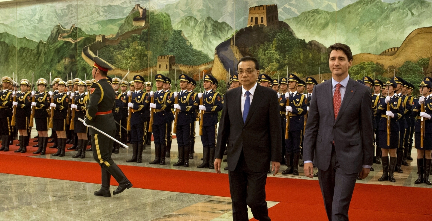 Canadian Prime Minister Justin Trudeau walks with Chinese Premier Li Keqiang during a welcome ceremony in Beijing, China on Dec. 4, 2017. (AP Photo/Ng Han Guan)