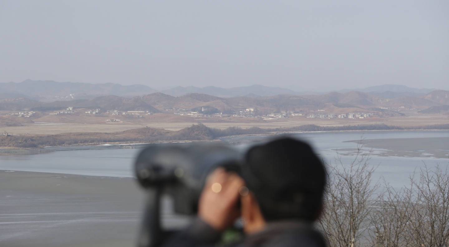 A visitor uses binoculars to see North Korea from the unification observatory in Paju, South Korea, Monday, January 1, 2018. (AP Photo/Lee Jin-man)