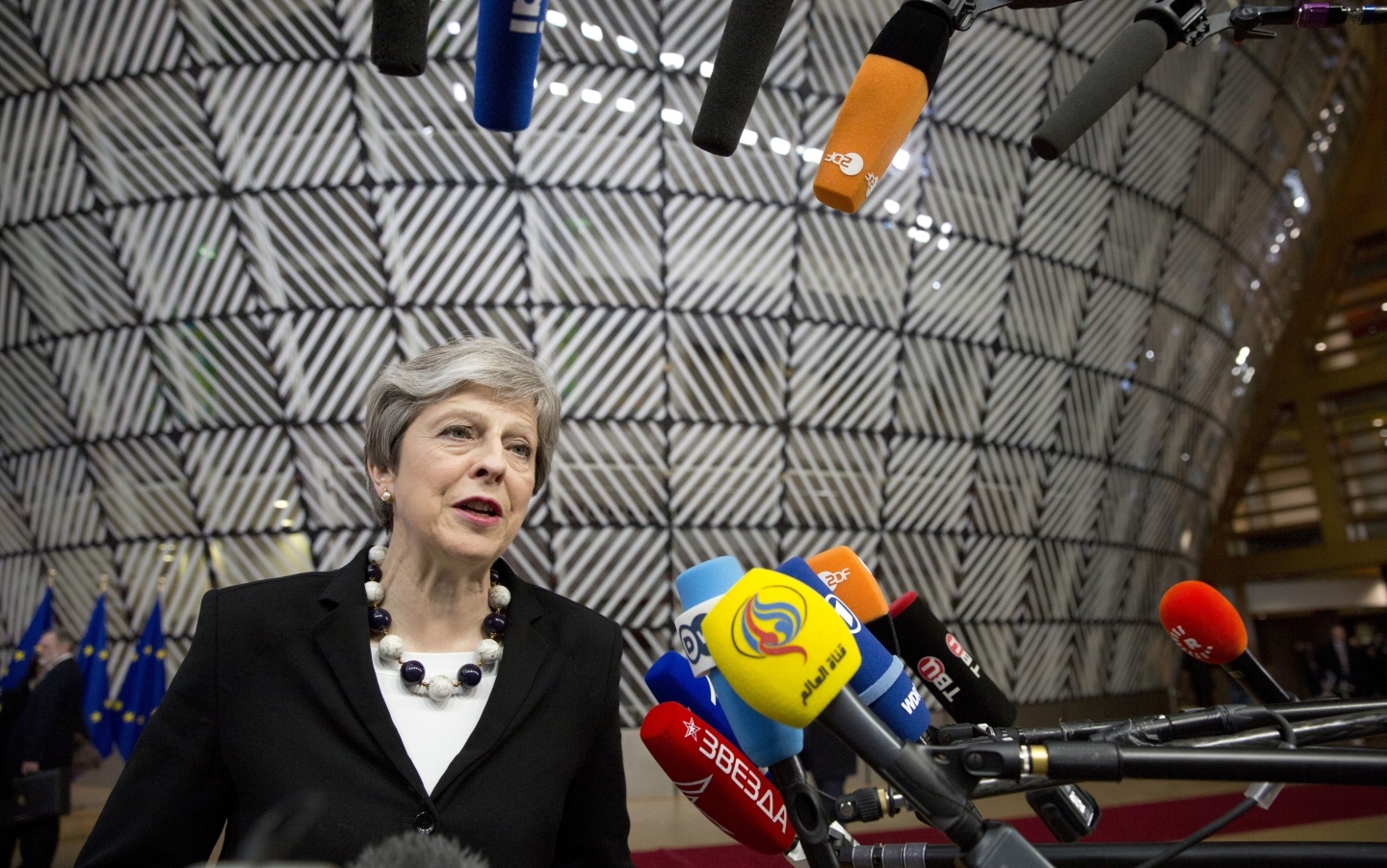 British Prime Minister Theresa May speaks with the media as she arrives for an EU summit at the Europa building in Brussels on March 23, 2018. (AP Photo/Virginia Mayo)