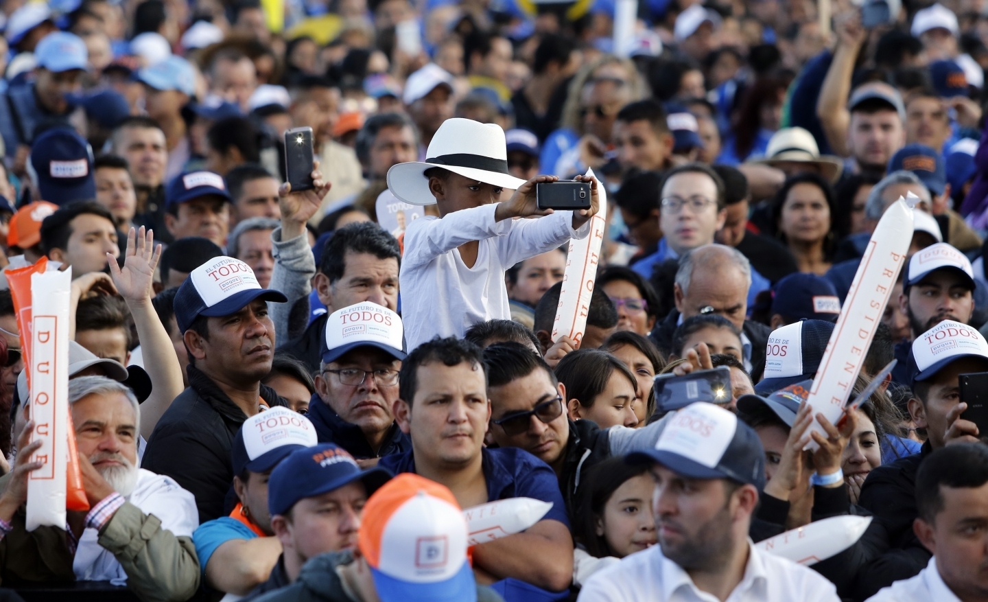 Supporters listen to Ivan Duque, presidential candidate for Democratic Center party, during his campaign rally in Bogota, Colombia on May 20, 2018. (AP Photo/Fernando Vergara)